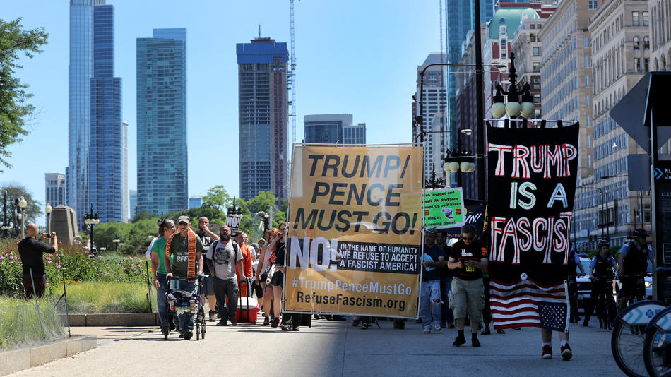People march through downtown Chicago demanding the resignation of President Donald Trump and weighing in on other issues. Chris Sweda / Chicago Tribune